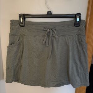 Black and gray stripes athletic skirt with shorts underneath.